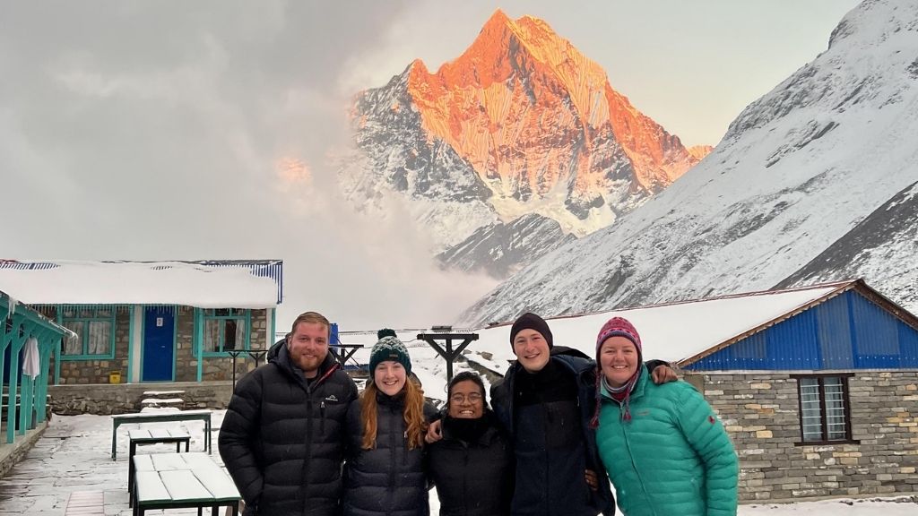 trekkers standing in front of Machhapuchhre at local teahouse at ABC